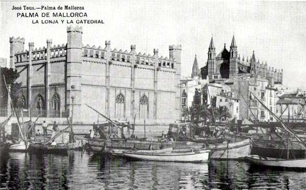 View of the impressive cathedral with old fishing boats in the foreground.