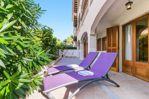 Comfortable veranda with sun loungers.